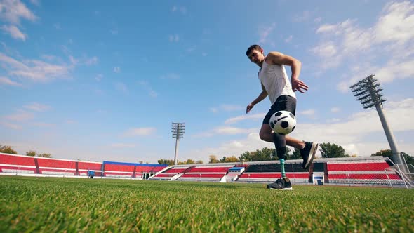 Stadium with a Handicapped Man Playing with a Ball