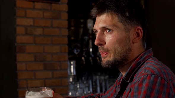 Mature Man Toasting with His Beer To the Camera