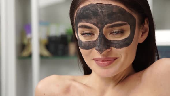 Portrait of Pretty Woman with Carbonic Mask for Peeling