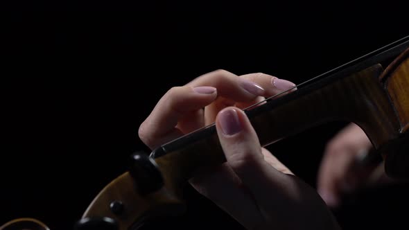 Close Up Fingers of a Musician Sifting the Violin