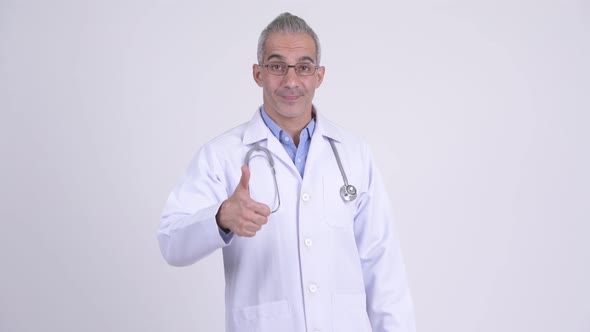 Happy Persian Man Doctor Giving Thumbs Up Against White Background