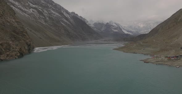 Aerial Flying Over Calm Waters Of Attabad lake In Hunza Valley. Dolly Forward