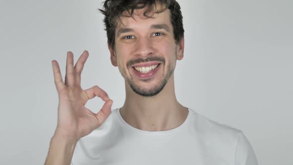 Portrait of Excited Young Casual Man Gesturing Victory Sign