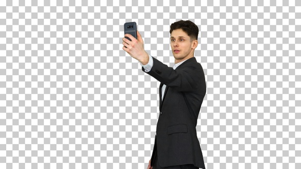 Young business man walking and taking a selfie, Alpha Channel