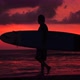 Silhouette of Young Surfer Man Walking on the Beach Near Ocean with Amazing Sunset on Background - VideoHive Item for Sale