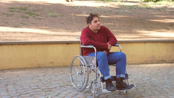 living with disability - lonely man with paraplegia at park looks around