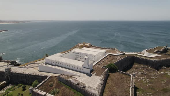 Strategically built Peniche Fortress on cliff overlooking Atlantic; aerial