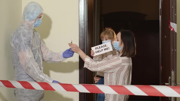 Doctor with Vaccine Visiting Mother with Daughter at Home Offering Vaccination Against Coronavirus