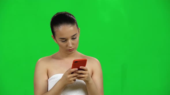 Girl in Towel Uses Phone for Work. Green Screen