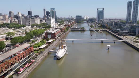 Aerial establishing shot flying over Puerto Madero docks in Buenos Aires city at daytime