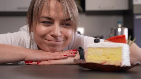 Portrait of Woman Looking at Piece of Cake at Home