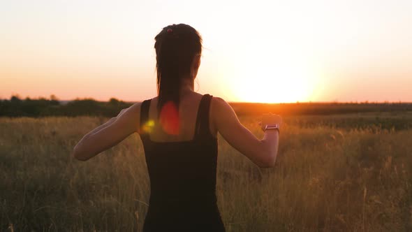 Young Woman Doing Warm-up at Sunset. She Is Getting Ready To Go Jogging or Sports