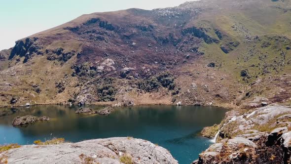 4k daytime video with a beautiful deep blue lake in the Peruvian Andes at the Lagoons of Pichgacocha