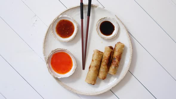 Fried Chinese Thai or Vietnamese Traditional Spring Rolls or Nems Served on Ceramic Plate
