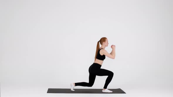 Athletic Young Female Making Jumping Lunges Exercise While Training in Studio