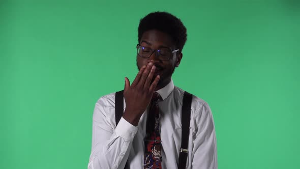 Portrait of Young African American Man Looking at Camera Listening to Boring Information and Yawning