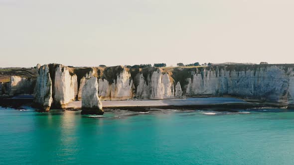 Beautiful Scenic Aerial View of Sunset Normandy Azure Sea Coastline and Majestic White Sunny Cliffs