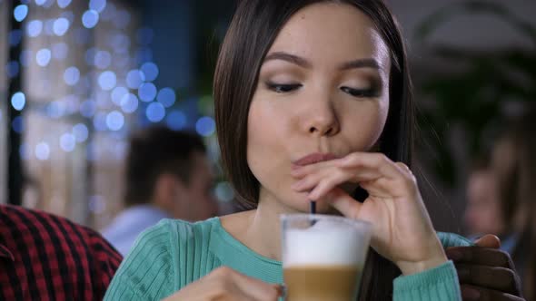 Portrait of Pretty Asian Woman Drinking Latte