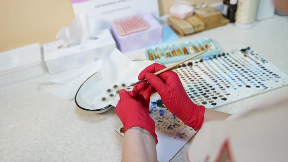 Glass eye prosthetic production. Close up of coloring artificial eye prosthesis