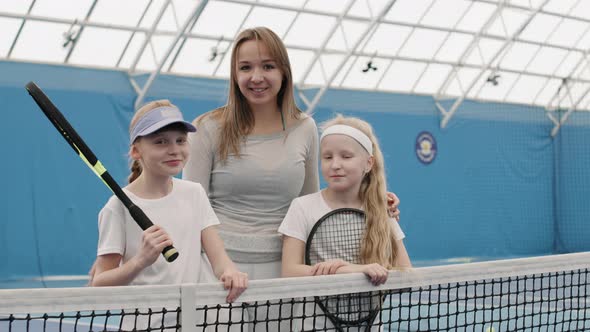 Portrait Of Tennis Coach With Little Players