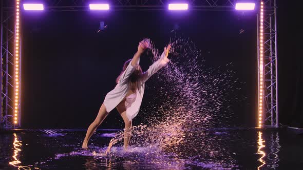 Woman in White Shirt and Beige Bodysuit is Dancing Dramatic Dances of Modern Ballet in Rain