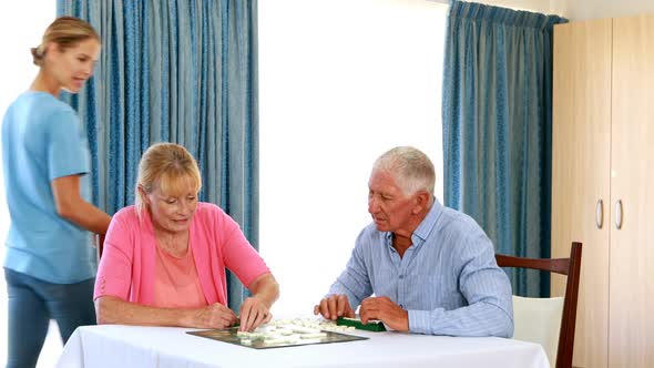 Senior couple playing puzzle