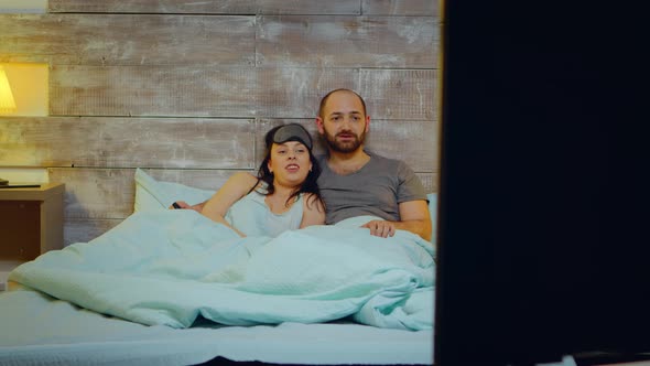 Couple Wearing Pajamas Lying in Bed