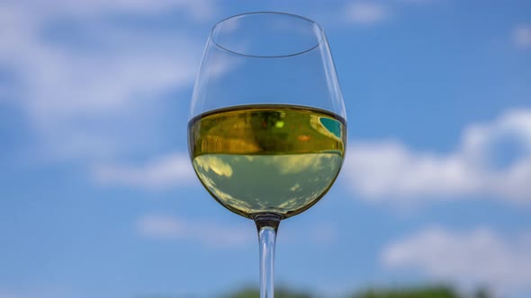 Glass of White Wine Against Blue Sky