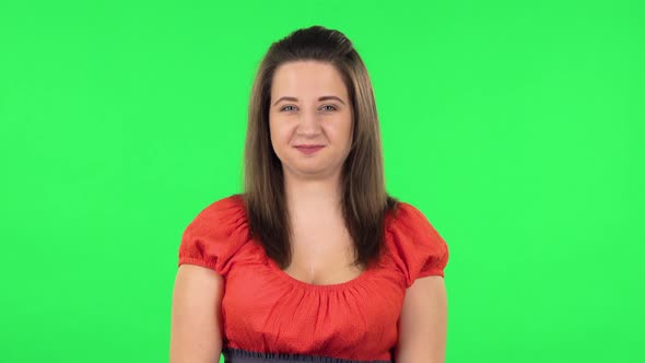 Portrait of Funny Girl Is Smiling Broadly and Winking. Green Screen