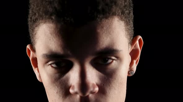 Portrait of a Young African American Basketball Player in a Dark Studio on a Black Background