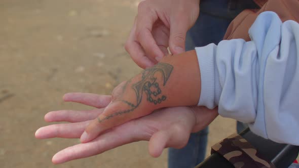 Social worker doing massage to disabled person. Congenital amputations. Close up