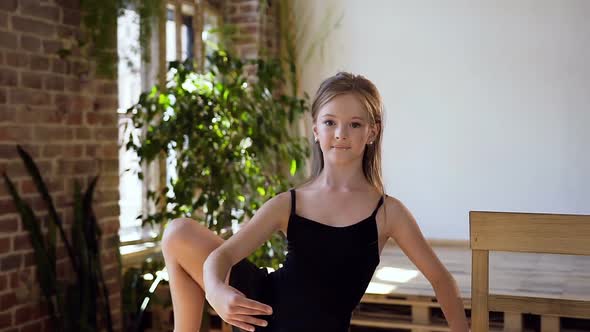 Charming Girl in Black Tutu Performs Element of Classical Ballet 