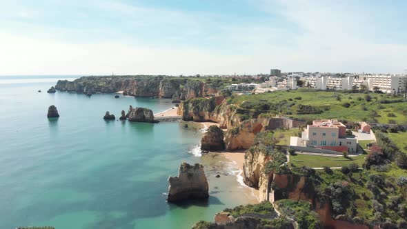 Luxury mansion by the beach, coast of Lagos , Algarve. Aerial forward