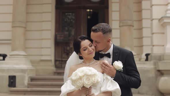 Newlyweds Portrait Caucasian Groom Bride Walking Embracing Hugs Near Old Castle Wedding Couple