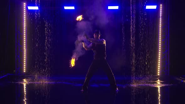 Male Artist Performing Fire Show in Slow Motion at Night. Fireshow in in a Dark Studio Under