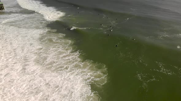 Epic drone tracking shot of surfer riding a wave.