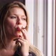 Face of a young woman while smoking a cigarette - VideoHive Item for Sale
