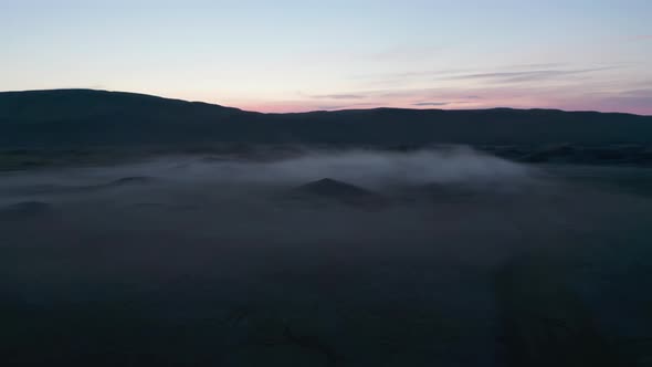 Backwards Fly Above Hazy Landscape