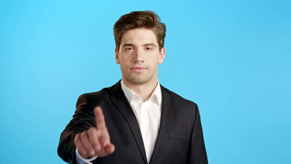Portrait of Serious Businessman in Professional Suit Showing Rejecting Gesture By Stop Finger Sign