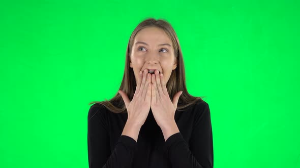 Portrait of Awkward Teenage Girl Is Wearing Braces with Shocked Wow Face Expression on a Green