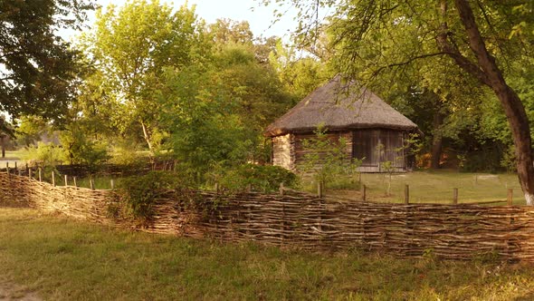 Old Village Wooden Log House and Wicker Hedge