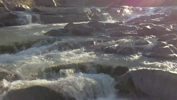 Wild mountain river flowing with stone boulders and stone rapids. Probiy river in the Carpathians