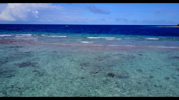 Aerial drone shot seascape of marine coast beach voyage by blue ocean with white sand background of 