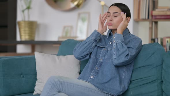 Latin Woman with Headache on Sofa 