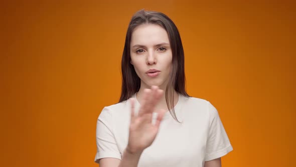 Young Woman Expressing Aversion Rejection Negative Attitude Against Yellow Background