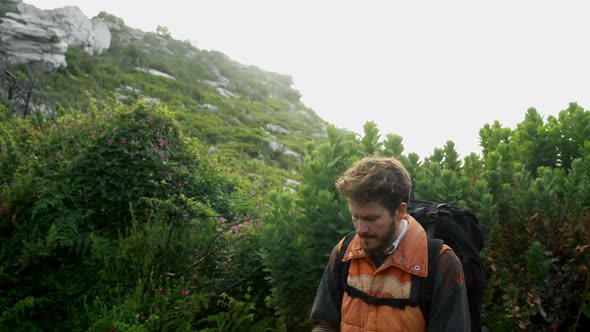 Male hiker taking photo with mobile phone 4k