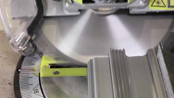 Worker cutting baseboard on the circular saw before installing.