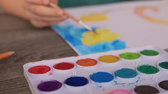 Little Boy with Colors Drawing Picture at Home