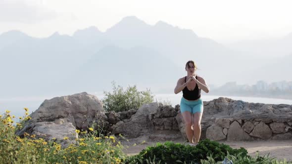 A Sporty Woman Training on a Rocky Elevation