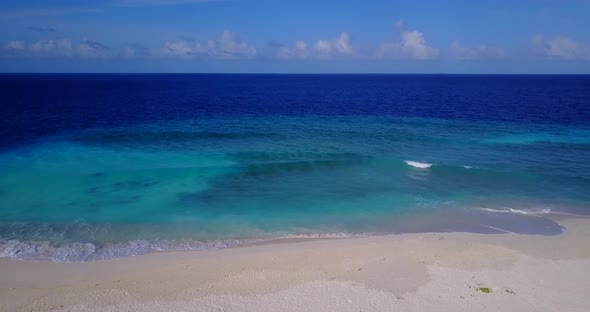 Wide aerial clean view of a sunshine white sandy paradise beach and blue sea background in high reso